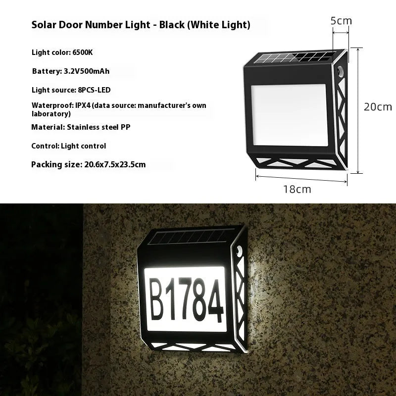 Black solar doorplate light with LED illumination showing house numbers