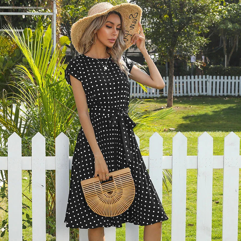 A classic polka dot midi dress with a buttoned style, perfect for summertime