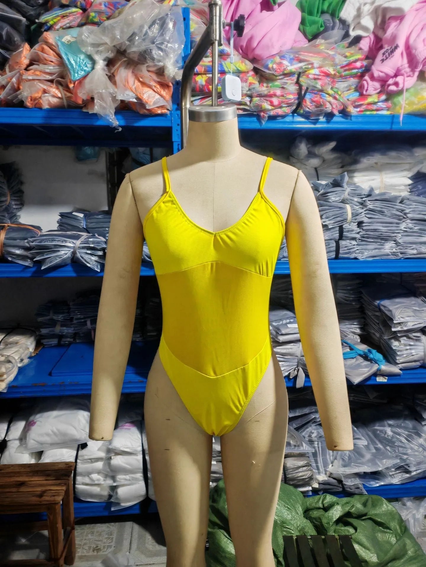 Black banded bikini one-piece swimsuit made of transparent polyester on a mannequin.
