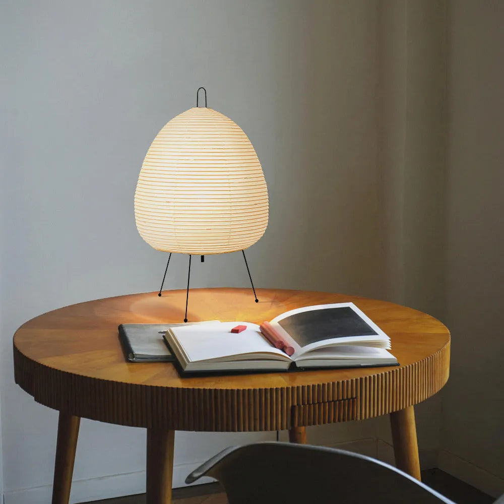 Japanese style table lamp with a white handmade rice paper shade on a slim aluminium base.