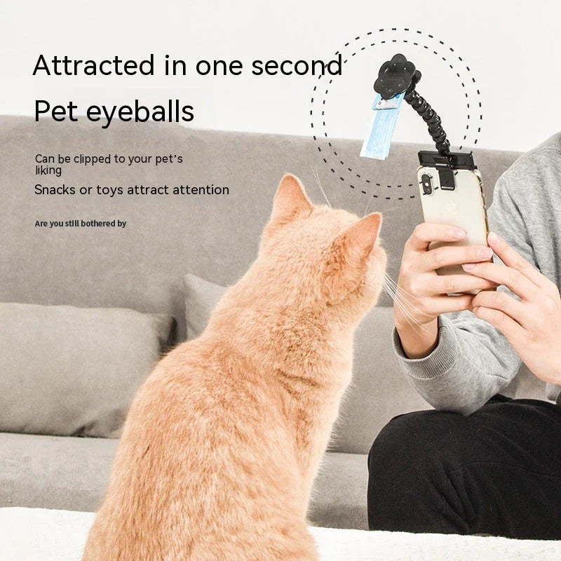 Multifunctional pet camera holder and selfie clip that securely attaches to your phone or mobile device and allows you to capture your furry friend's most playful moments with ease.