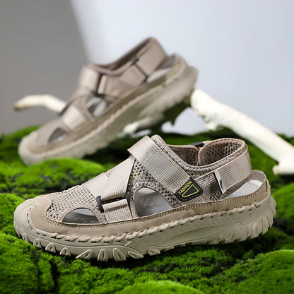 Men's gray casual sandals with mesh panels, leather upper, elastic strap, and rubber sole.