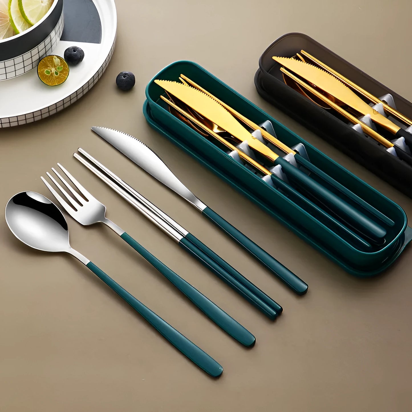 Gold and black stainless steel knife fork spoon set inside a grey mesh carrying bag.