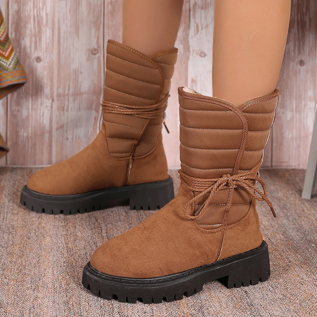 Women's black suede snow boots with chunky heel, fleece lining, and lace-up design for winter wear