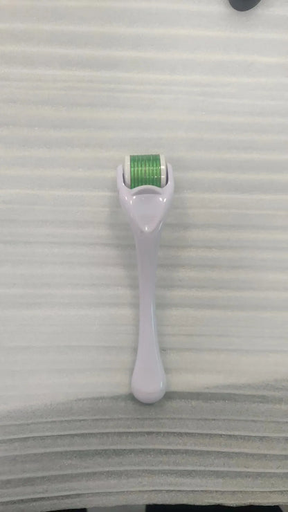 Sterile micro needle derma roller with black handle and coloured wheel on white background