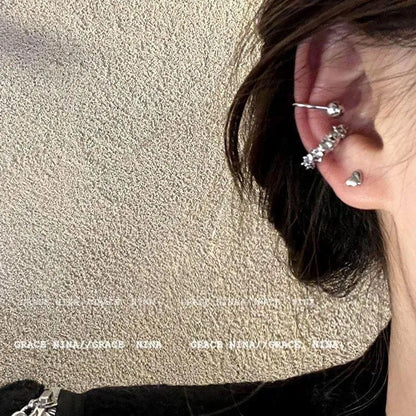 A pair of frosty-finish geometric clip-on earrings with an irregular abstract shape.