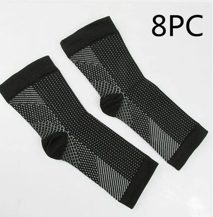 Anti-fatigue compression foot sleeve in black, red, or white, featuring moisture-wicking fabric and a heel hole for breathability.
