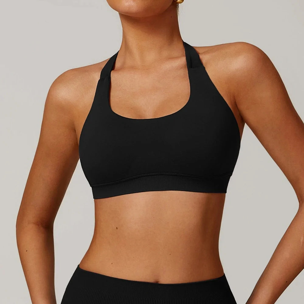 Women's halter yoga bra with hollow design in plum purple colour showing medium support construction