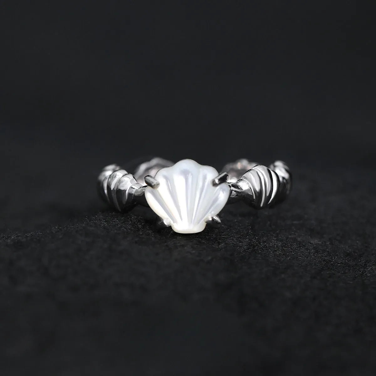 Adjustable silver ring with tiger eye stone centrepiece and shell design in electroplated finish