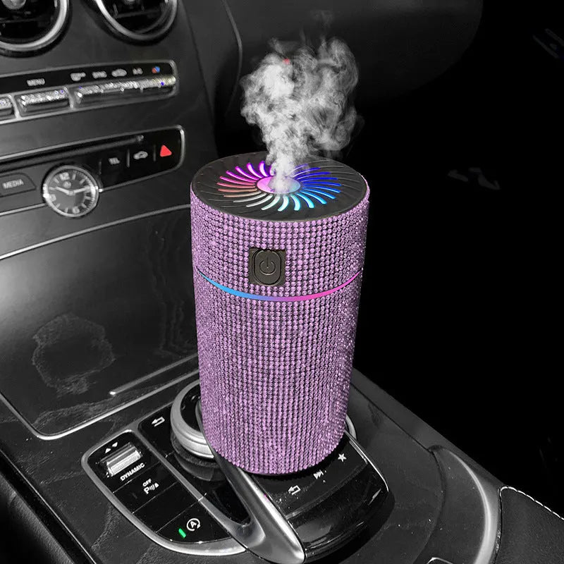 Compact white car air purifier and humidifier unit with USB cable on a car dashboard.
