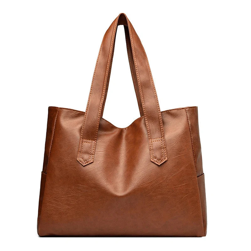 Stylish large capacity commuter shoulder bag in brown and black, perfect for autumn and winter fashion.