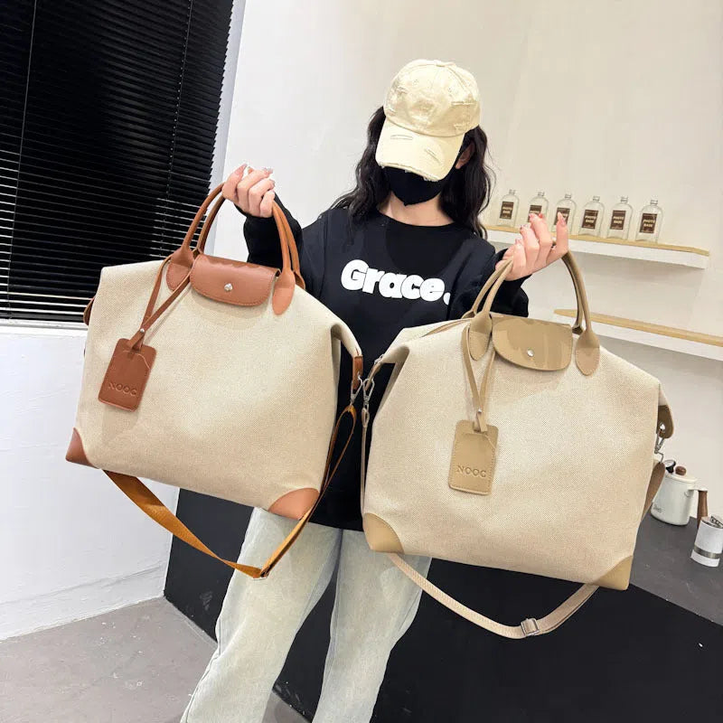 Large capacity canvas yoga and fitness bag in brown, khaki, or black with polyester lining and shoulder strap.