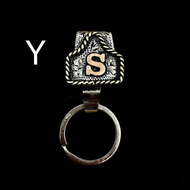 Handmade cow tag design metal keychain on a keyring, shown in one of many available colours.