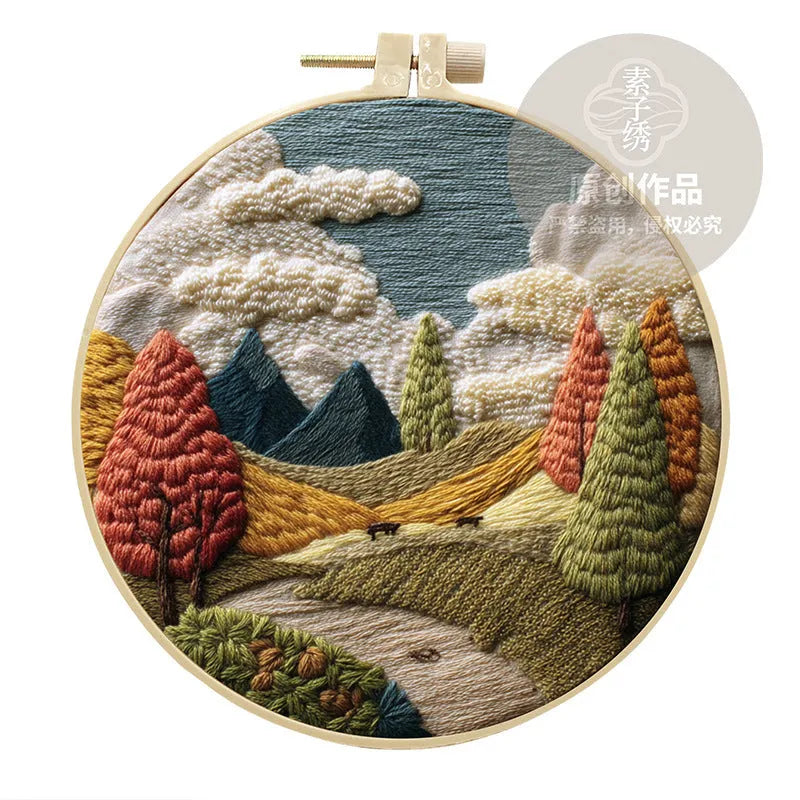 Complete DIY embroidery kit with 15cm bamboo frame, pre-printed landscape fabric, threads, and needles laid out.