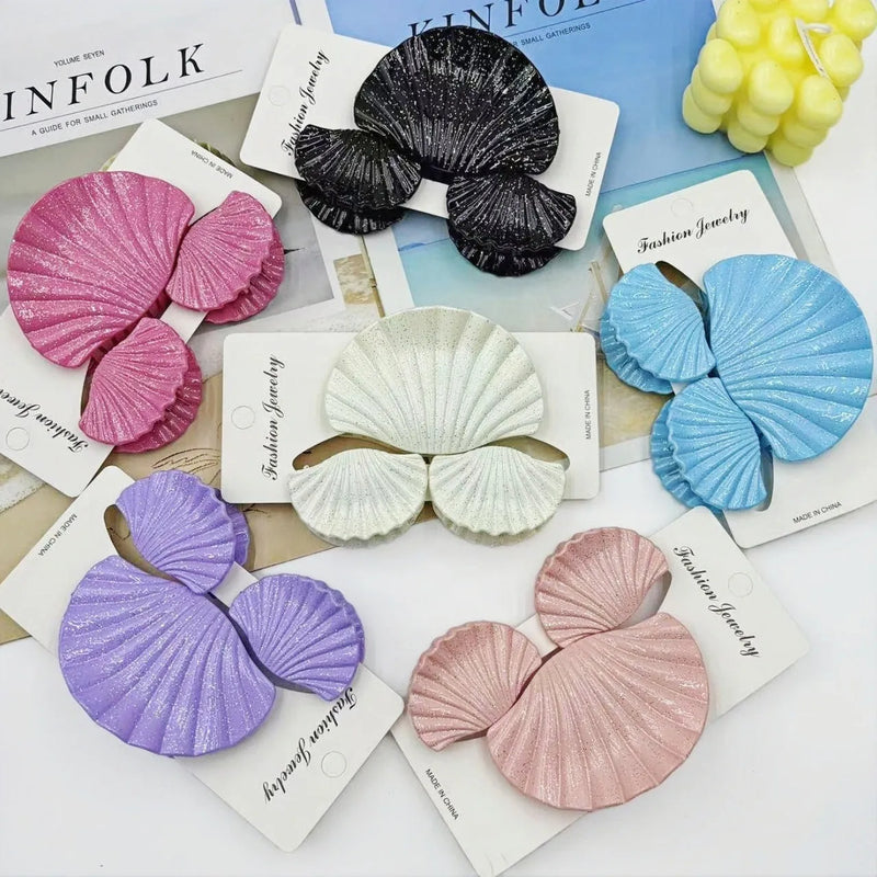 Plastic hair clip set with gradient frosted finish in multiple colour options including pink and blue, yellow and purple, and thin glittering styles suitable for women's hair accessories, sold as three-piece sets with shell-inspired decorative elements.