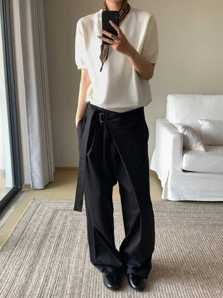 Black straight-leg trousers with single front pleat and adjustable waistband on a hanger