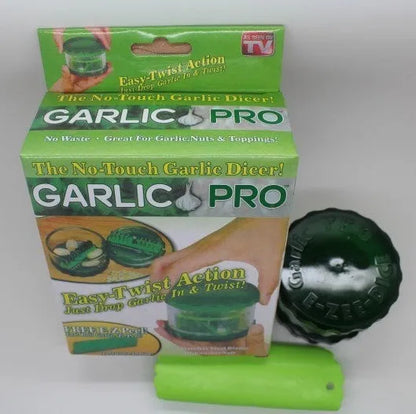 Transparent green garlic peeler measuring 8.5 by 8.5 by 6 centimetres with garlic cloves visible inside