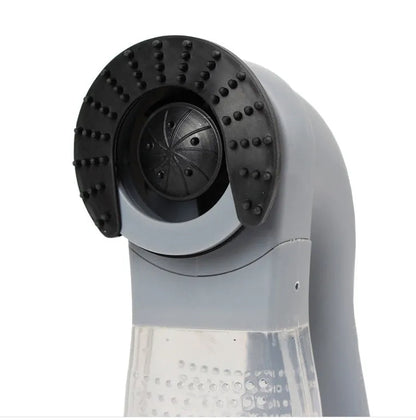 Grey handheld electric pet hair remover brush with soft rubber head for grooming dogs and cats.