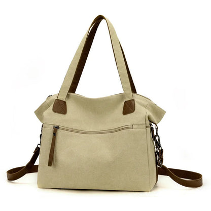 Large grey retro-style canvas shoulder bag with a horizontal square shape and multiple internal pockets.