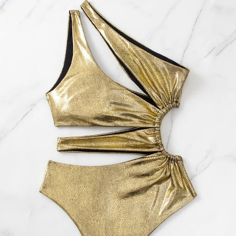 Gold backless one-piece swimsuit for women on a mannequin, showing sleeveless design.