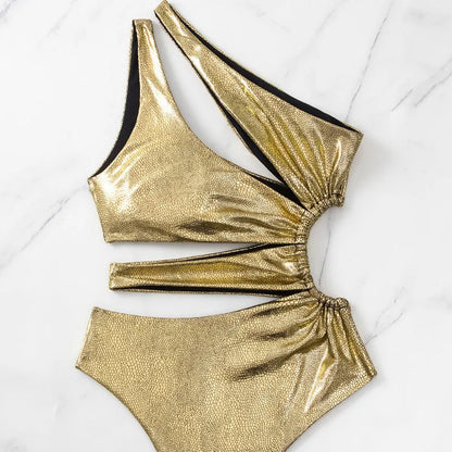 Gold backless one-piece swimsuit for women on a mannequin, showing sleeveless design.