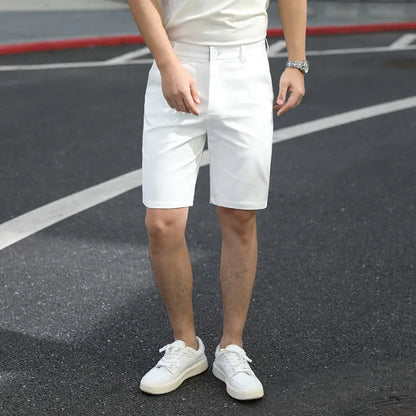 Man wearing loose-fit beige fifth pants with an elastic waistband, showcasing the mid-length casual style.