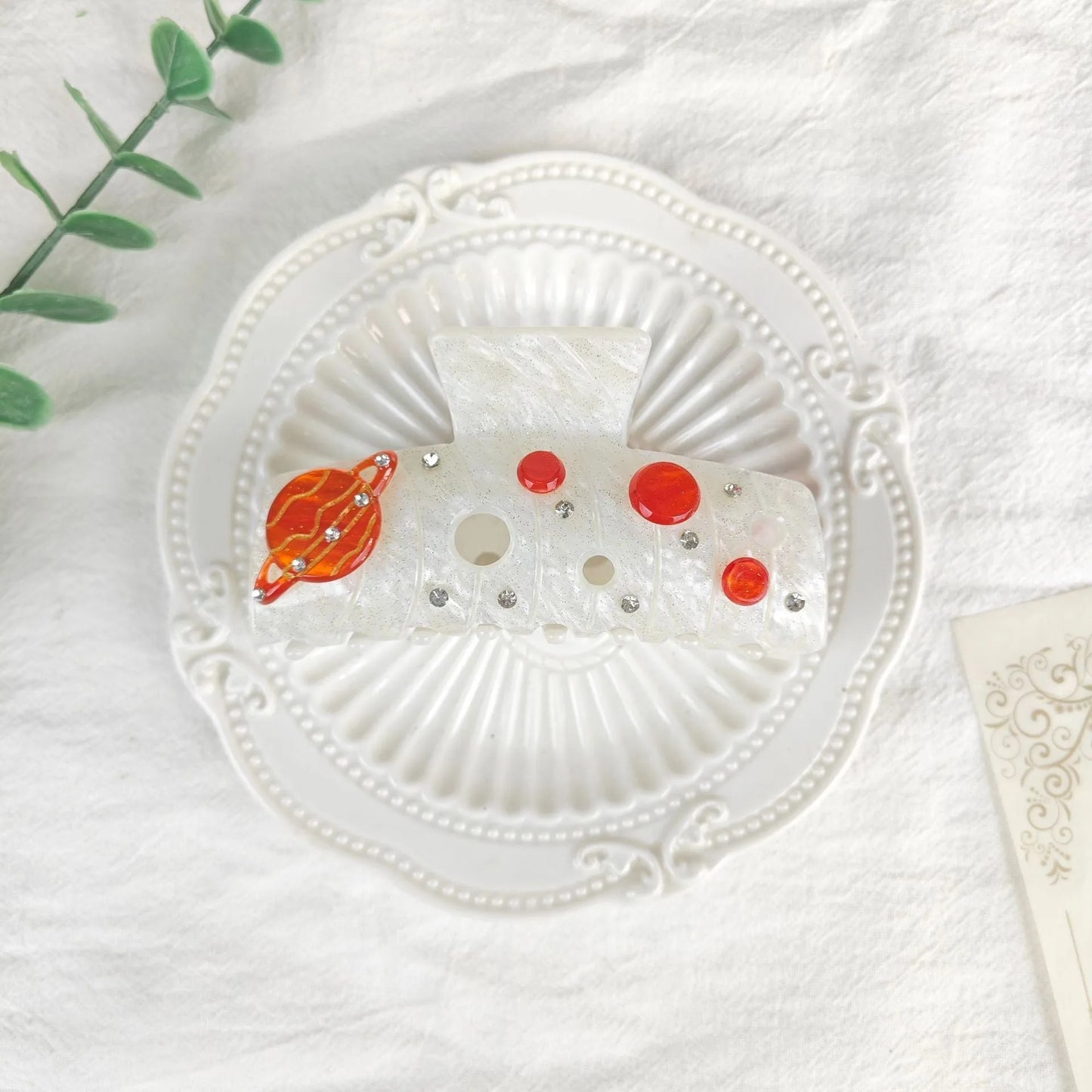 Oversized star barrettes in starry sky colours showing minimalist design and irregular elements