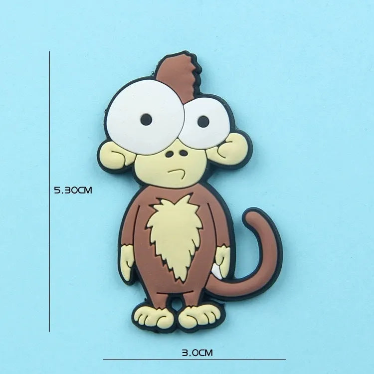 Nine PVC soft rubber cartoon animal fridge stickers including monkey, crocodile, leopard, lion, zebra, elephant, giraffe, and ostrich.