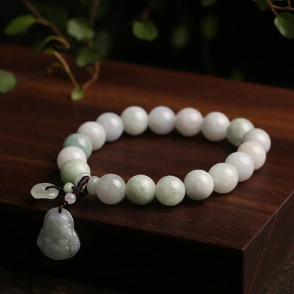 Natural green jade charm bracelet with carved apple and geometric stone pendants.