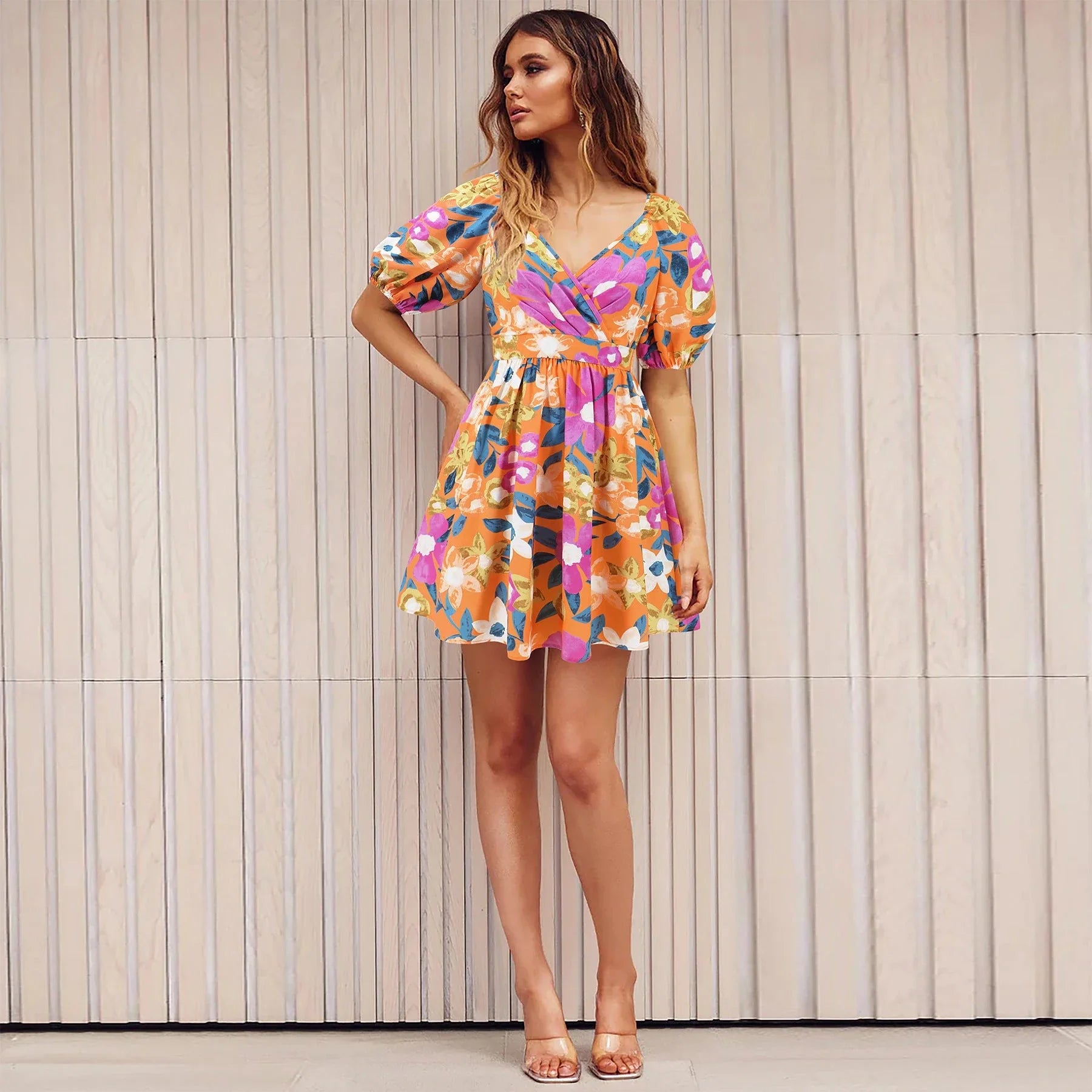 Stylish floral mini dress with V-neck and lantern sleeves, perfect for summer vacations and beach outings