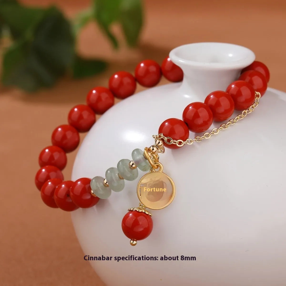 Retro women's bracelet with red cinnabar fu charm, jade bead, and tassel.