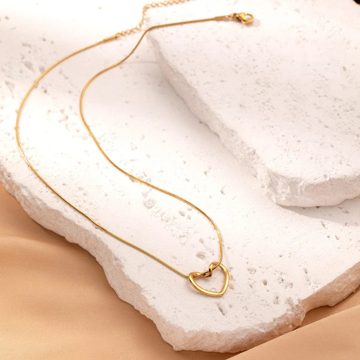 Elegant titanium steel heart pendant necklace with adjustable chain in gold and silver colors