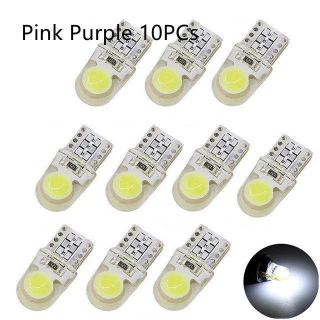 Pack of ten T10 wedge base LED car bulbs with COB chips in various colours on a white background