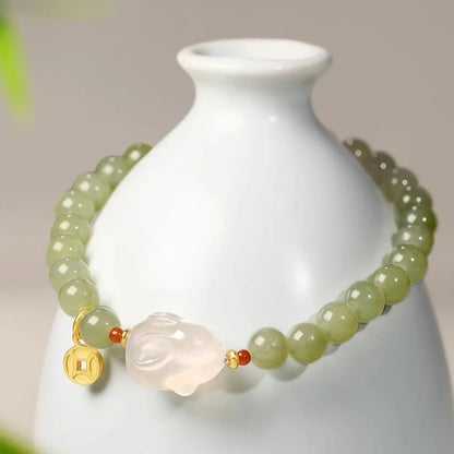Handmade women's bracelet with a glass rabbit charm on a coloured glaze chain.