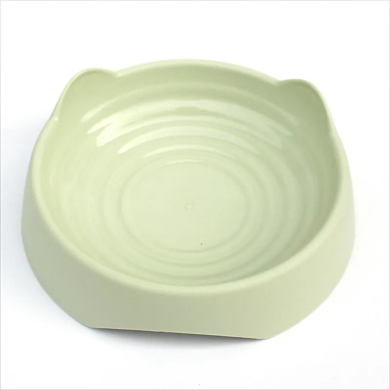 Blue ceramic dog slow feeder bowl with raised internal maze pattern for large breed dogs on a wooden floor.