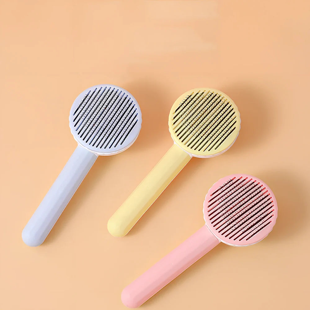 Self-cleaning cat comb with floating needle teeth and built-in hair storage chamber in assorted colours