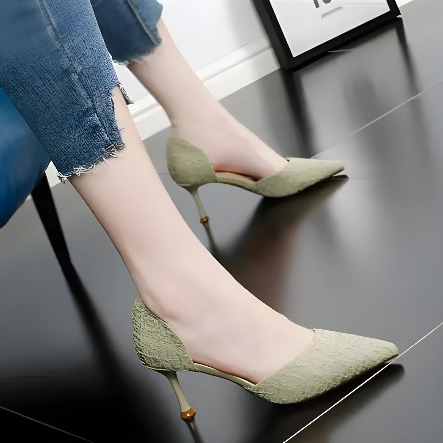 Women's black pointed toe stiletto heel sandals on a white background.