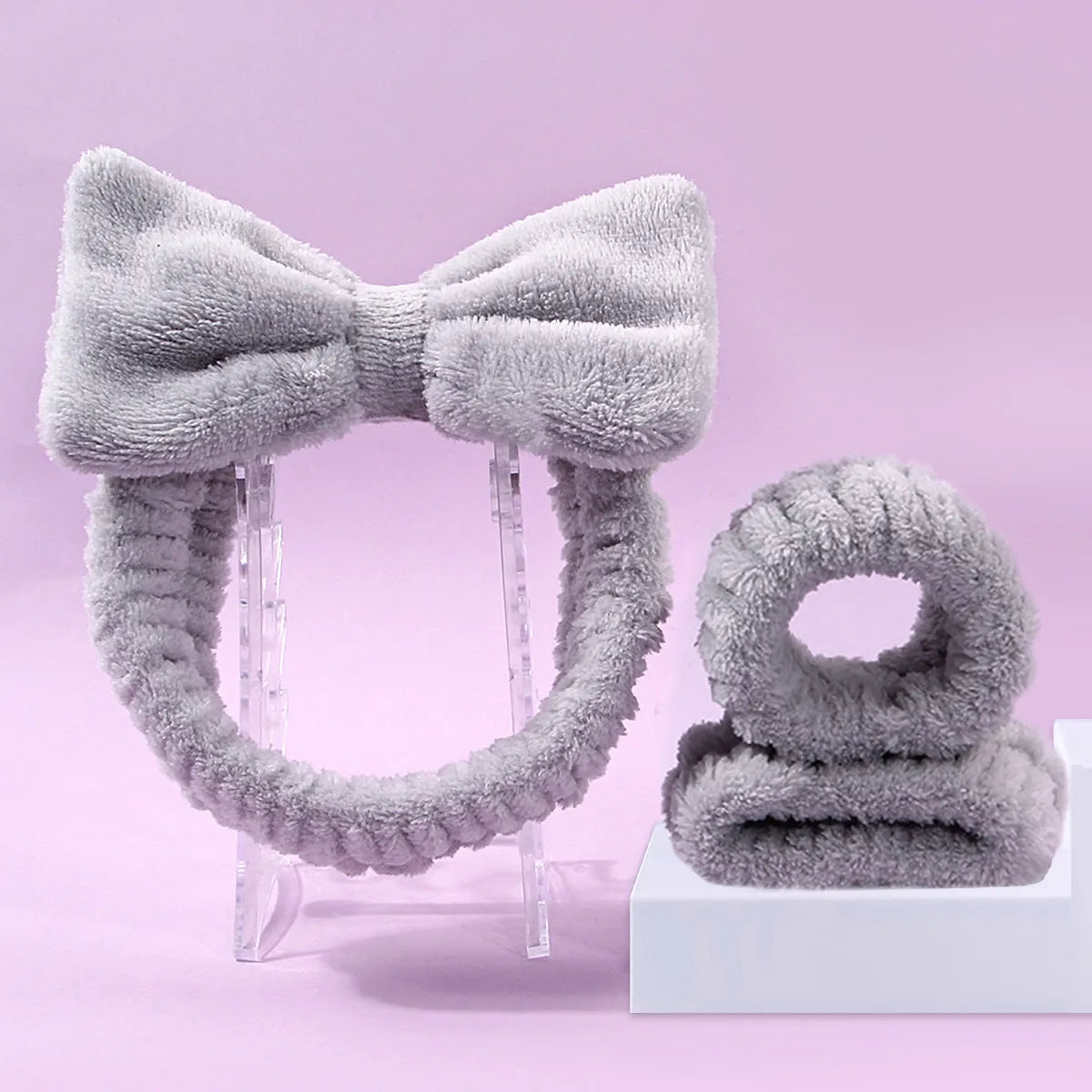 Facial brush set with coral fleece hair band and four nylon-bristle brushes in purple, grey, white, or pink colours