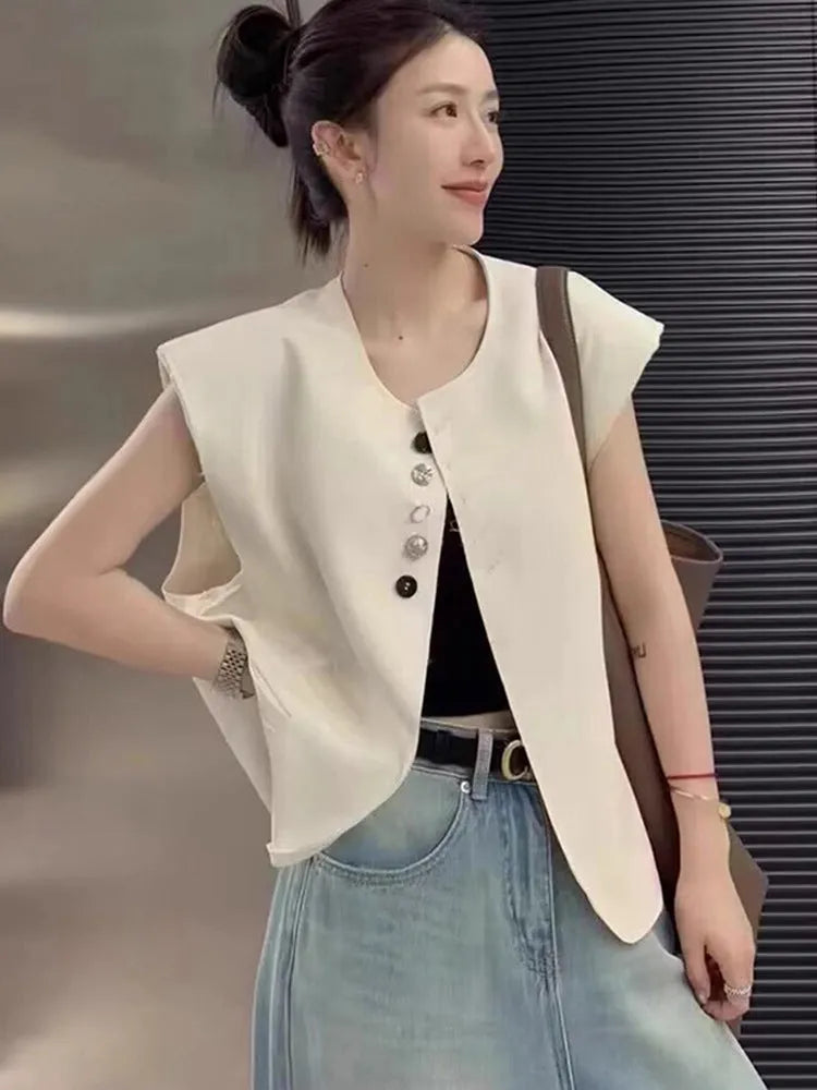 Beige loose-fit women's waistcoat with pockets on a hanger, showing short 40cm length and V-neck design.