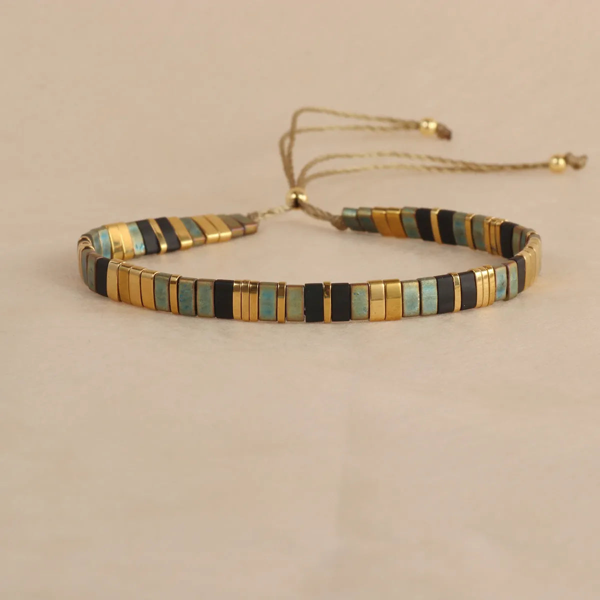 Geometric glass beaded pull bracelet in multiple colours including milky white, black, retro green, light blue, and red