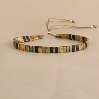 Geometric glass beaded pull bracelet in multiple colours including milky white, black, retro green, light blue, and red