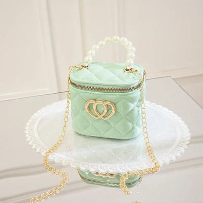 White PVC women's bucket bag with a heart-shaped pattern and shoulder strap.
