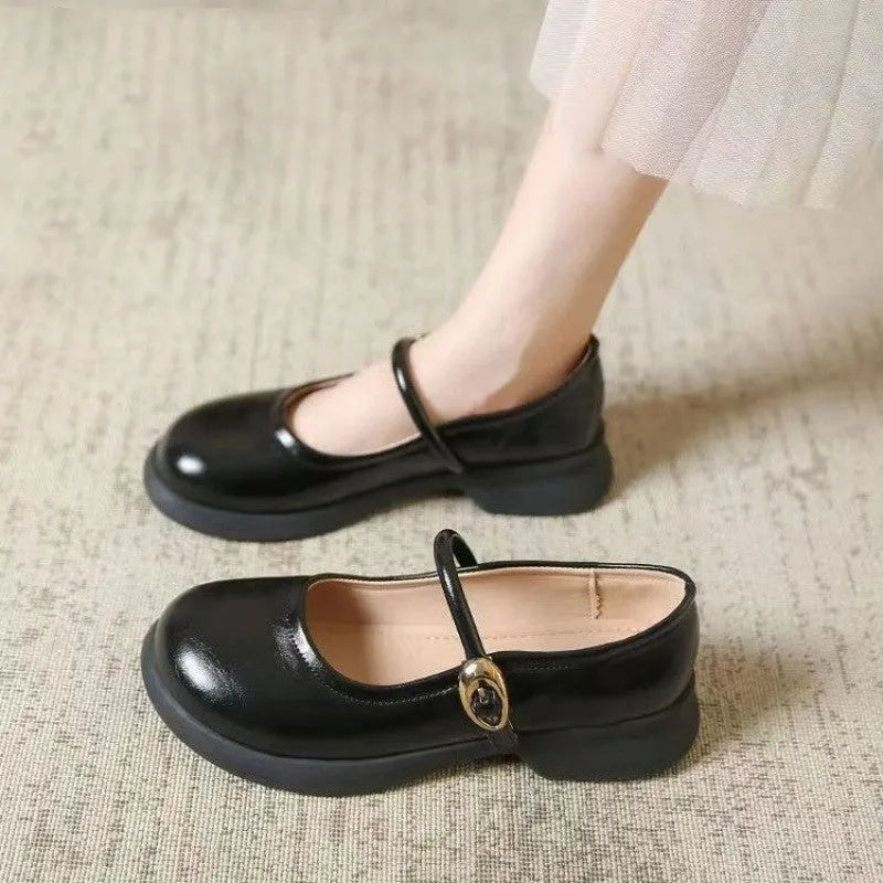 Flat leather shoes with wedge heel in black, featuring a skull pattern, round toe, and rubber sole.