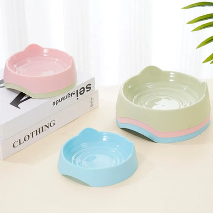 Blue ceramic dog slow feeder bowl with raised internal maze pattern for large breed dogs on a wooden floor.