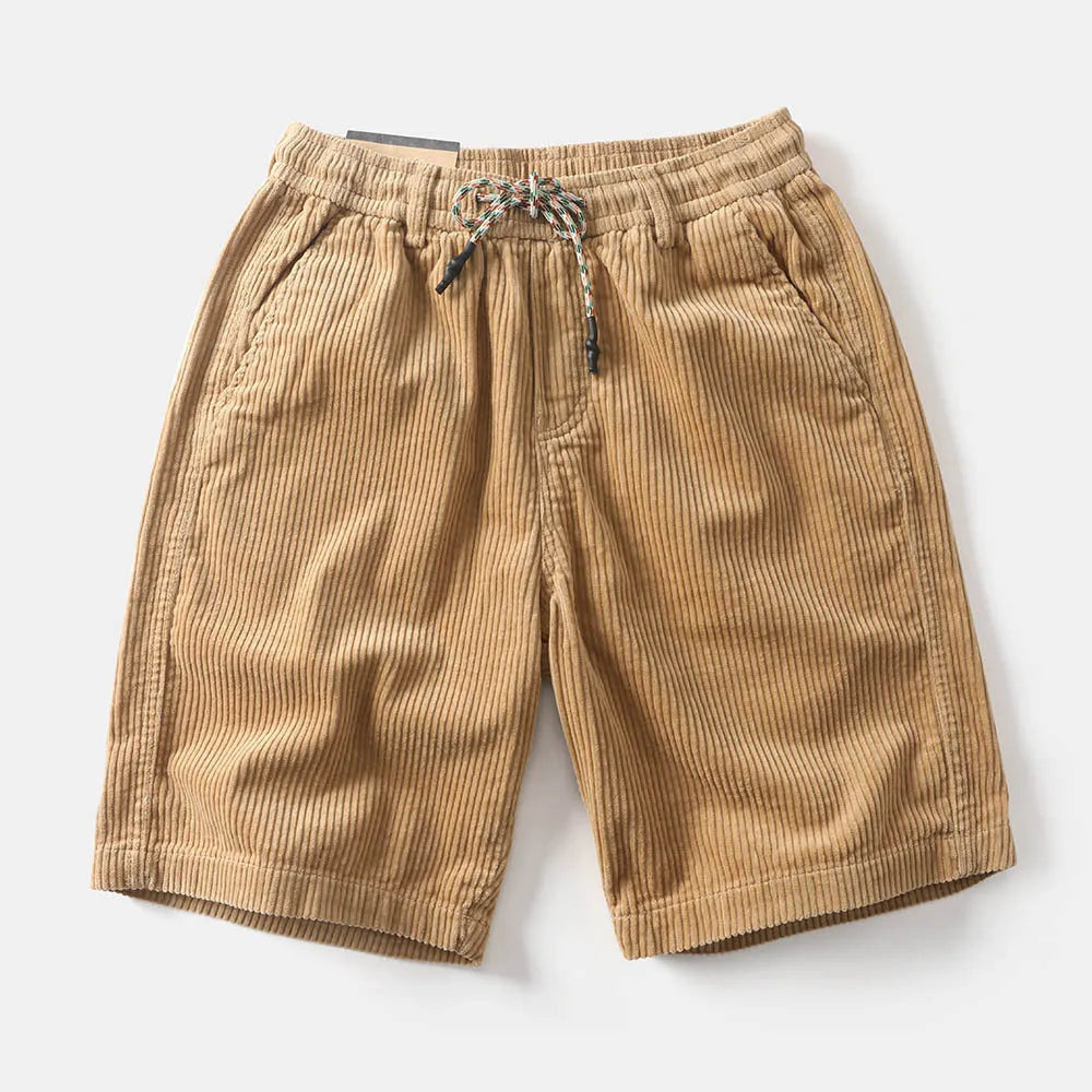 Men's khaki straight-leg cargo shorts with utility pockets, shown in a streetwear style.