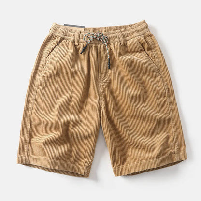 Men's khaki straight-leg cargo shorts with utility pockets, shown in a streetwear style.
