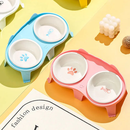 Ceramic cat food and water bowl set in elevated tilted stand, shown in blue, pink, white, and yellow colour options.