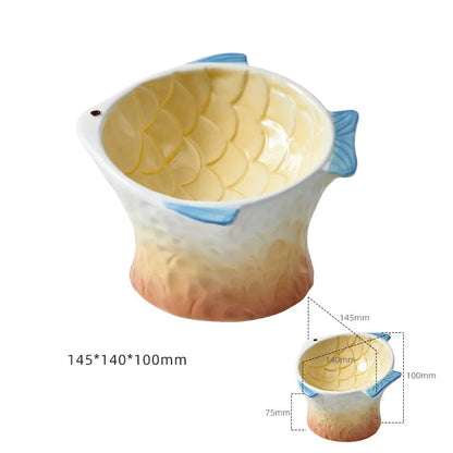 Set of four blue fish-shaped ceramic cat bowls with a tilted design on a wooden floor.