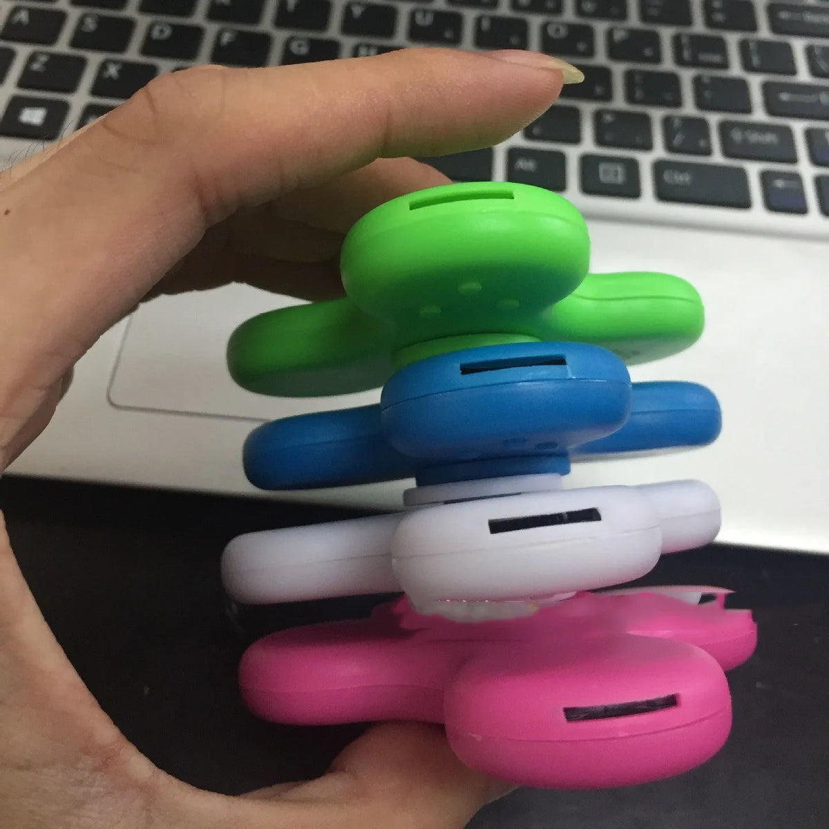 Square Bluetooth speaker music fidget spinner MP3 player in blue, showing button controls and compact design.