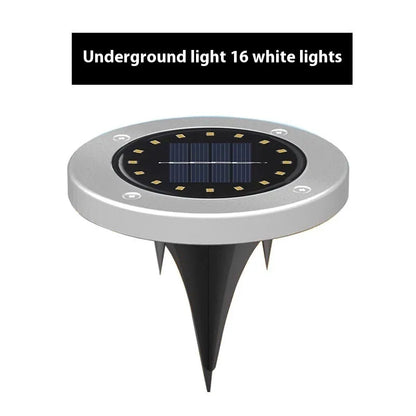 Stainless steel solar garden ground lamp installed in a lawn.